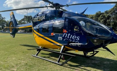 Close up of CareFlight's H145 helicopter, landed on a grassy field